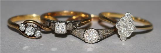 Four assorted 18ct gold and diamond set dress rings.